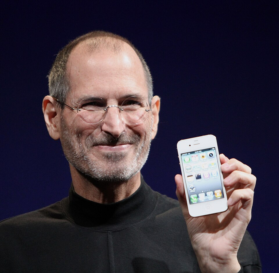 Portrait of Steve Jobs holding an iPhone